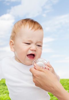 child and toddle concept - crying baby with dummy