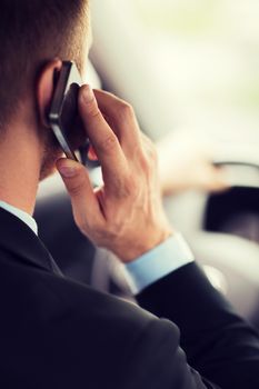 transportation and vehicle concept - man using phone while driving the car