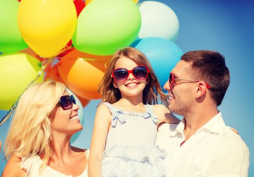 summer holidays, celebration, children and people concept - happy family with colorful balloons outdoors