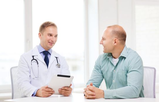 healthcare, technology and medicine concept - smiling doctor with tablet pc computer and patient in hospital