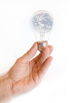 Environment conceptual image. Hand holds a light bulb with earth inside it.