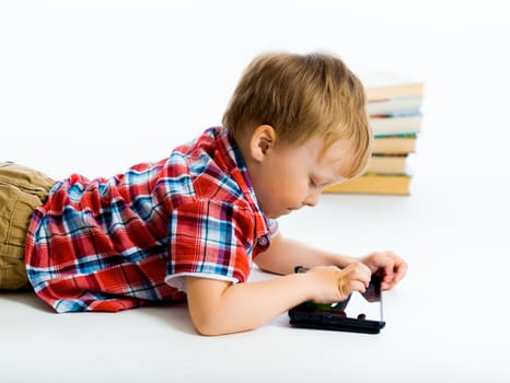 Little boy lying on the floor with tablet computer