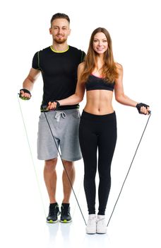 Happy athletic couple - man and woman with ropes on the white background