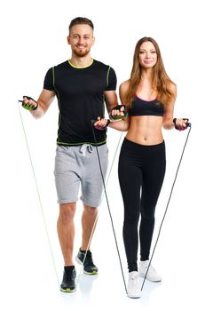 Happy athletic couple - man and woman with ropes on the white background