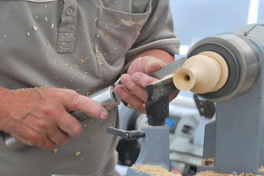 Man working at small wood lathe