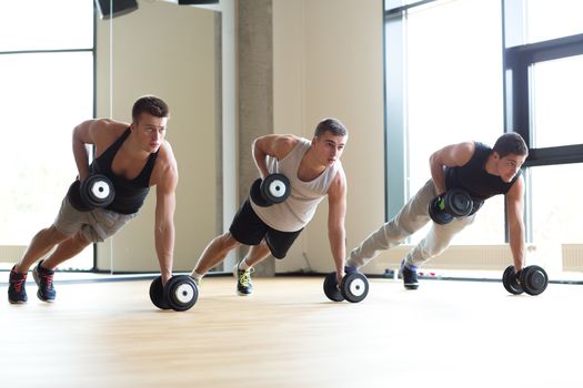 sport, fitness, lifestyle and people concept - group of men with dumbbells in gym