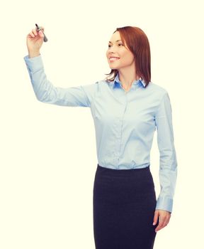 office, business and new technology concept - smiling businesswoman writing something in the air with marker