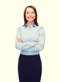 business and education concept - friendly young smiling businesswoman with crossed arms