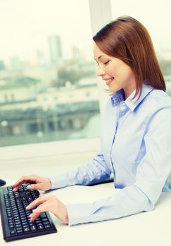 office, business, education, technology and internet concept - smiling businesswoman or student with computer