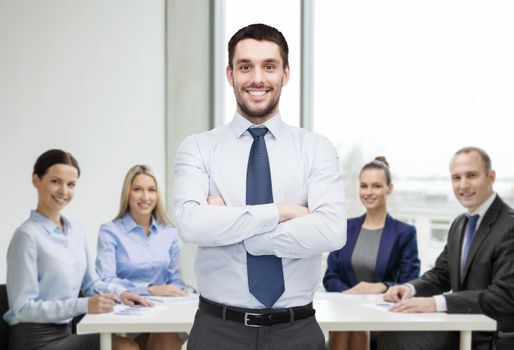 business and office concept - handsome businessman with crossed arms