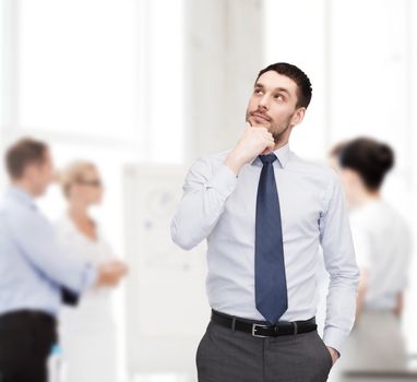 business and office concept - handsome businessman looking up