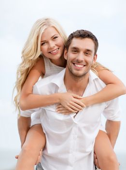 summer holiday, vacation, dating and tourism concept - happy couple having fun on the beach