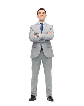 business, people and office concept - happy smiling businessman in suit