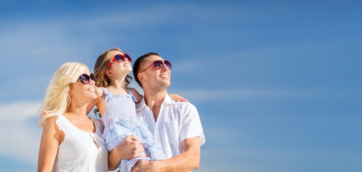 summer holidays, children and people concept - happy family with blue sky