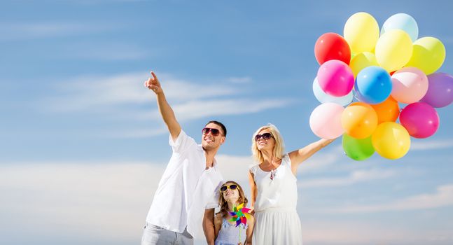 summer holidays, celebration, children and people concept - family with colorful balloons