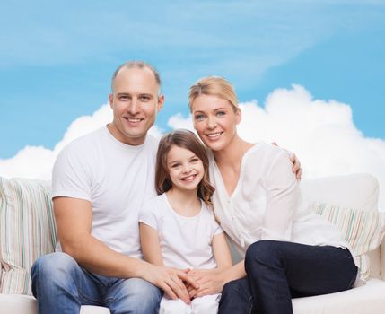 family, childhood and people concept - smiling mother, father and little girl over blue sky and white cloud background