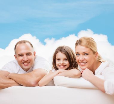 family, childhood and people - smiling mother, father and little girl over blue sky and white cloud background