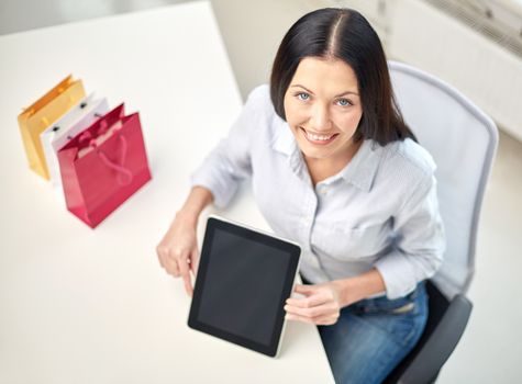 business, technology, communication and people concept - close up of woman with tablet pc computer at office or home