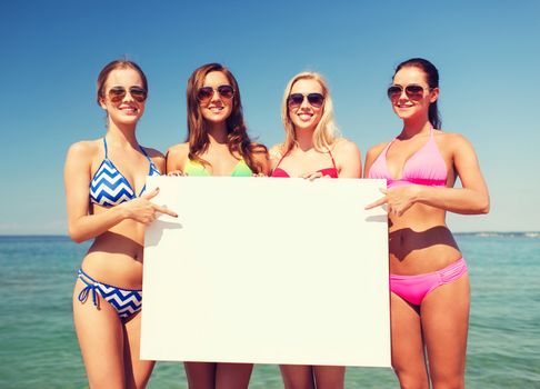summer vacation, holidays, travel, advertising and people concept - group of smiling young women with big white blank billboard on beach