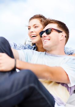 summer holidays and teenage concept - teenagers hanging out outside