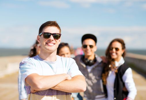 summer holidays and teenage concept - teenager in shades outside with friends