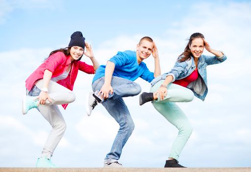 sport, dancing and urban culture concept - group of teenagers dancing