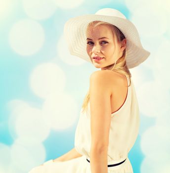 fashion and lifestyle concept - beautiful woman in hat enjoying summer outdoors