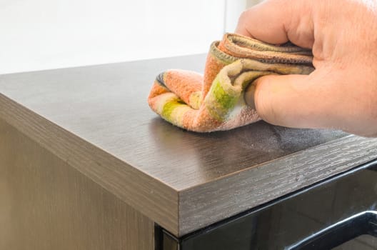 Dust cleaning and polishing a bathroom cabinet