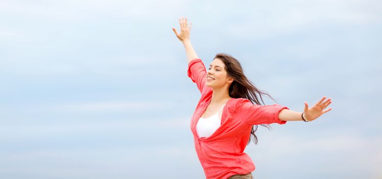 summer holidays and vacation - girl with hands up on the beach