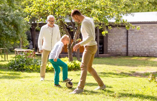 family, happiness, generation, home and people concept - happy family playing football in front of house outdoors