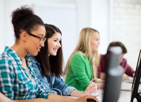 education, technology and internet - students with computers studying at school