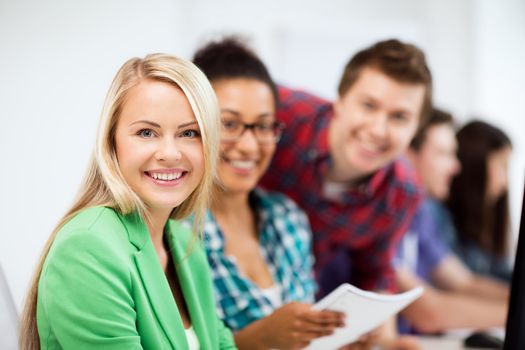 education, technology and internet - students with computer studying at school