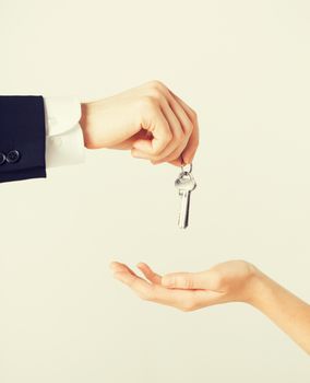 picture of man hand passing house keys to woman