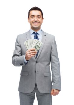 business, people and finances concept - smiling businessman with american dollar money