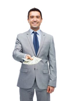 business, people and finances concept - smiling businessman with american dollar money