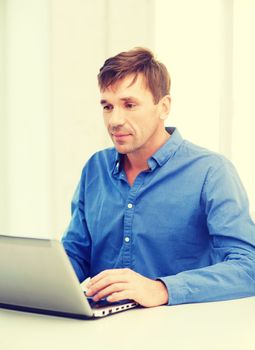 technology, business and lifestyle concept - man working with laptop at home