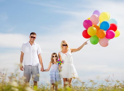 summer holidays, celebration, children and people concept - family with colorful balloons