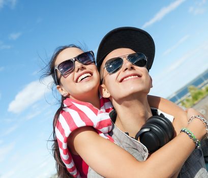 summer holidays and teenage concept - teenagers having fun outside