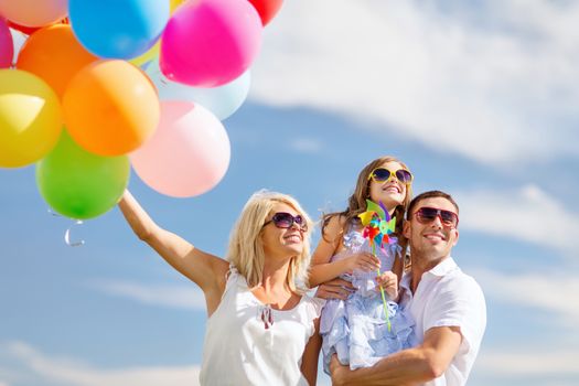 summer holidays, celebration, children and people concept - family with colorful balloons