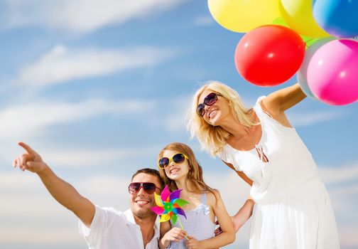 summer holidays, celebration, children and people concept - family with colorful balloons