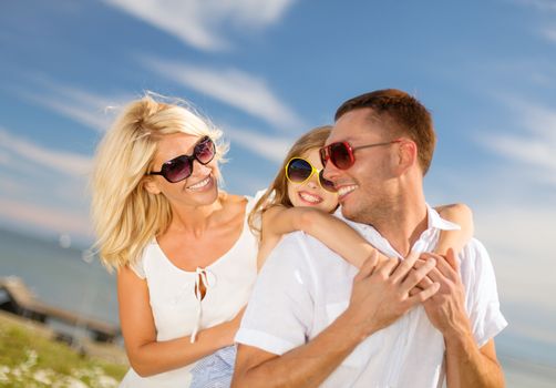 summer holidays, family, children and people concept - happy family in sunglasses having fun outdoors