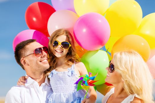 summer holidays, celebration, children and people concept - family with colorful balloons