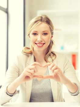 bright picture of young woman showing heart sign