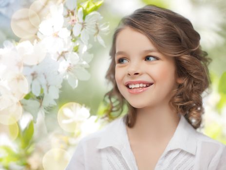people, children, season and happiness concept- happy girl over summer or spring garden background