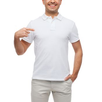 happiness, advertisement, fashion, gesture and people concept - smiling man in t-shirt pointing finger on himself