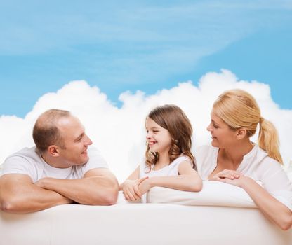 family, childhood and people - smiling mother, father and little girl over blue sky and white cloud background