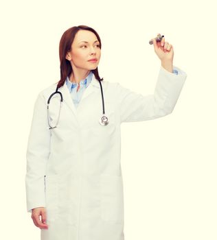 healthcare, medical and technology concept - young female doctor with stethoscope writing something in the air