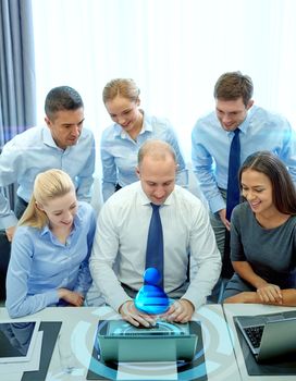 business, people, technology and teamwork concept - smiling business team with laptop computer and virtual projection working in office