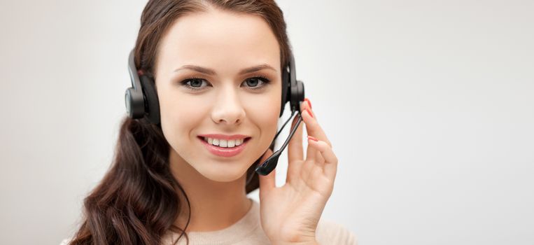 business and office concept - friendly female helpline operator with headphones