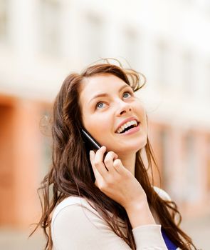 young woman talking on the phone outdoors